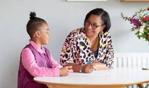 Niña haciendo la tarea junto a su madre y cumpliendo con sus horarios de actividades